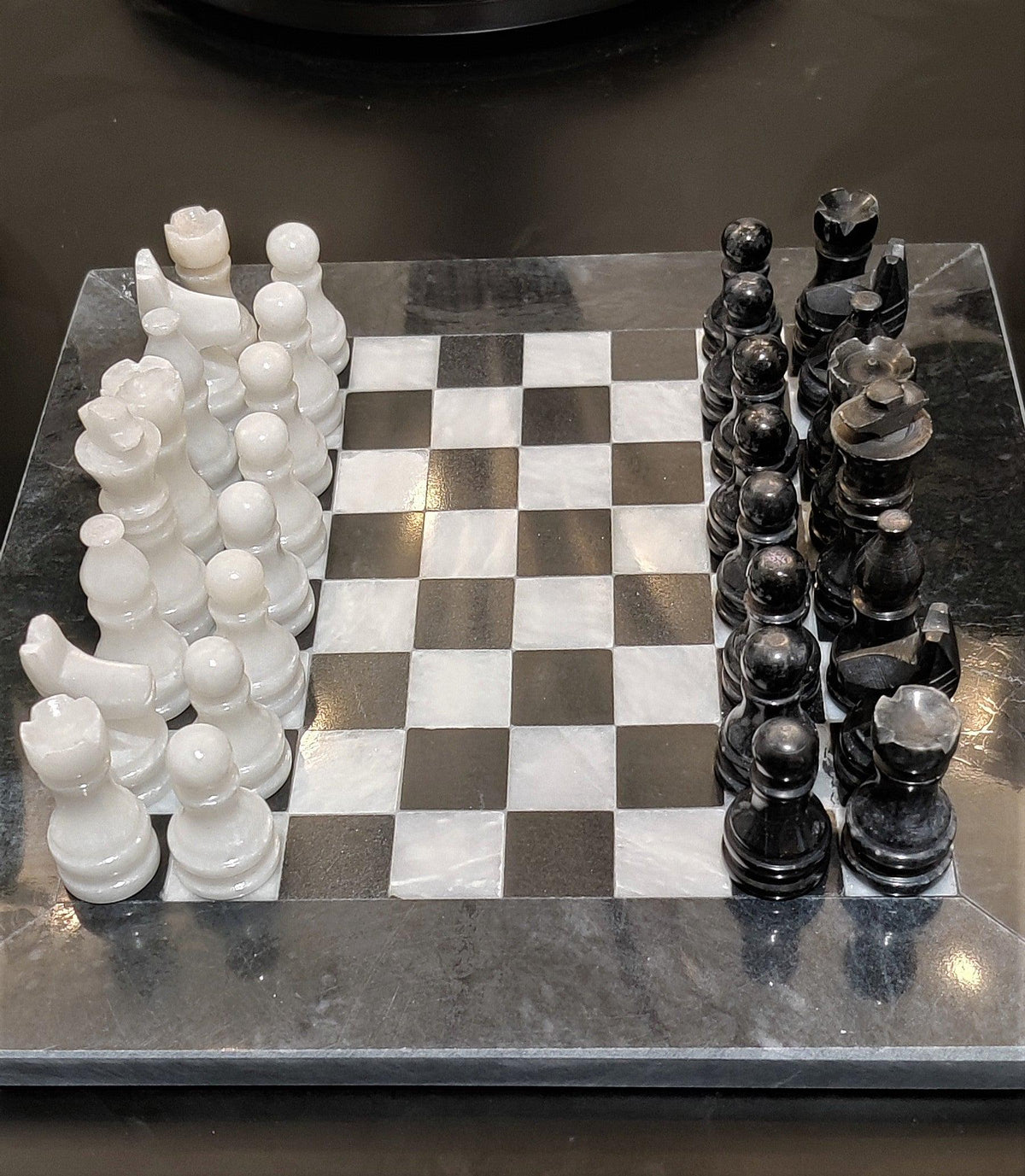 Top view of black and white 8 inch chessboard with pieces