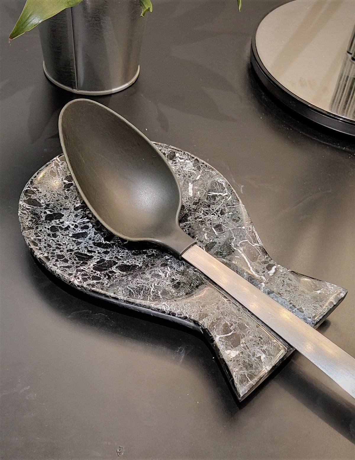 Close-up of black marble spoon rest with white veining