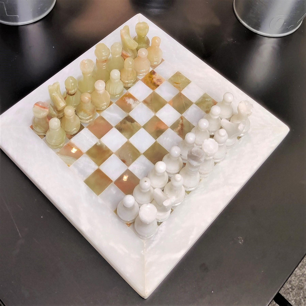 Green onyx and white chess set, angled view