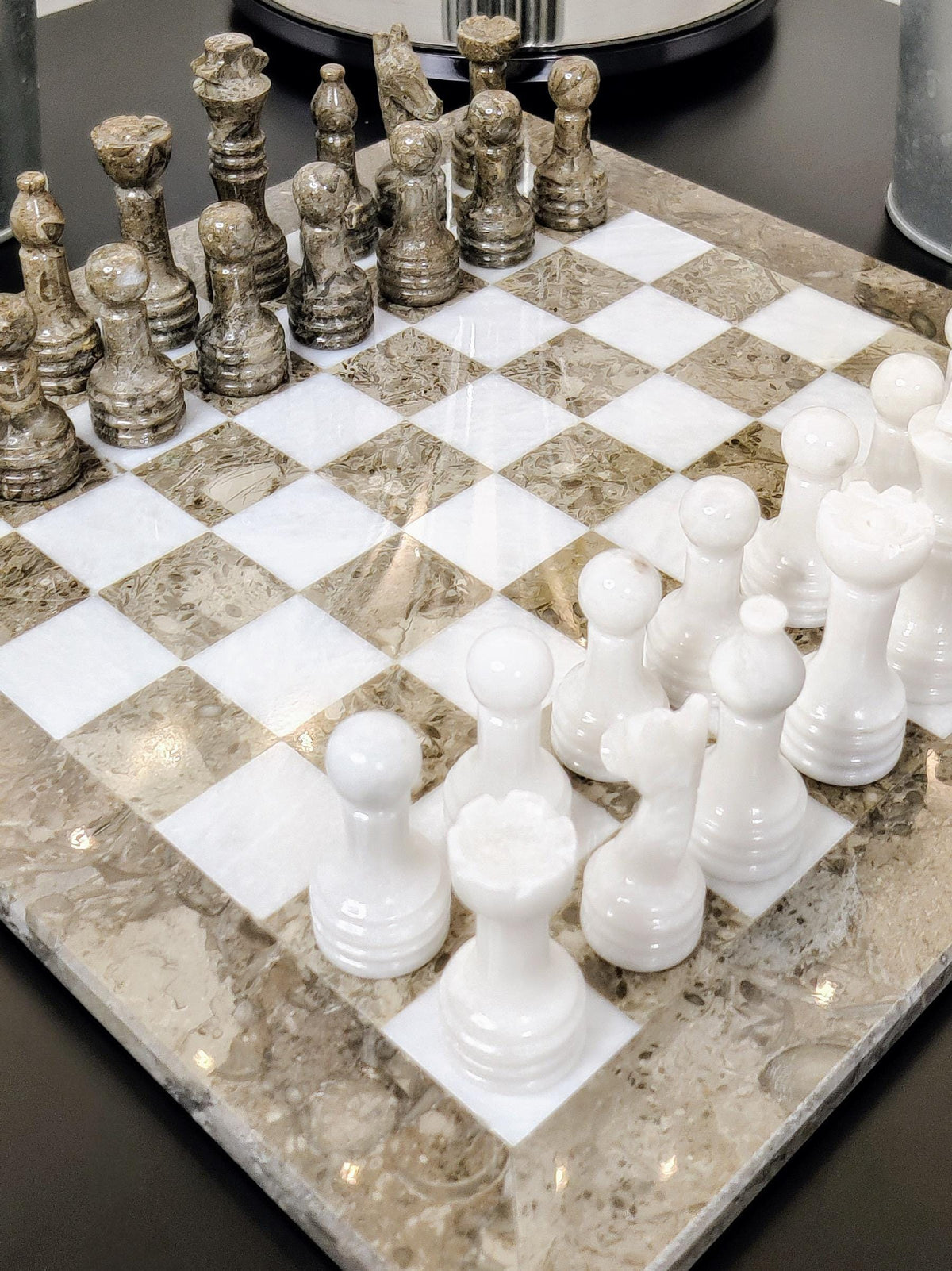 White marble pieces and grey pieces on a grey and white board