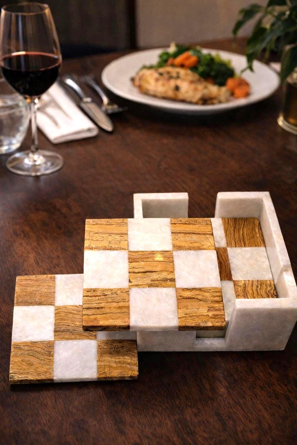 Brown and white marble coasters with a glass of red wine and dinner