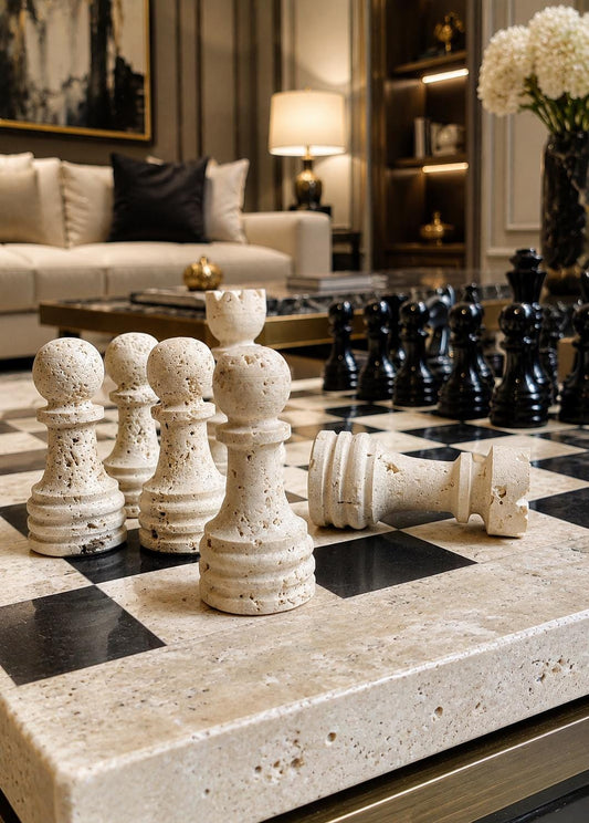 Close-up of travertine chess pieces with a toppled pawn in a living room